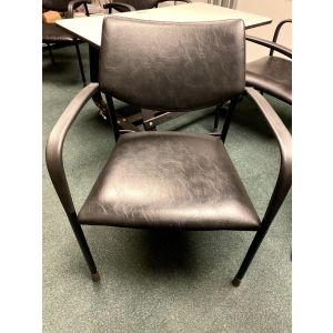 Front view of Pre-owned Gunlocke side chair has a black leatherette seat and back. With black loop arms and (4) post legs. -B GRADE-